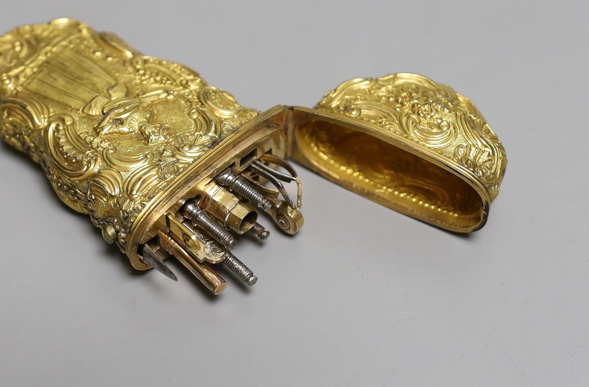 A George III gilt metal etui containing accessories, 10cms high.